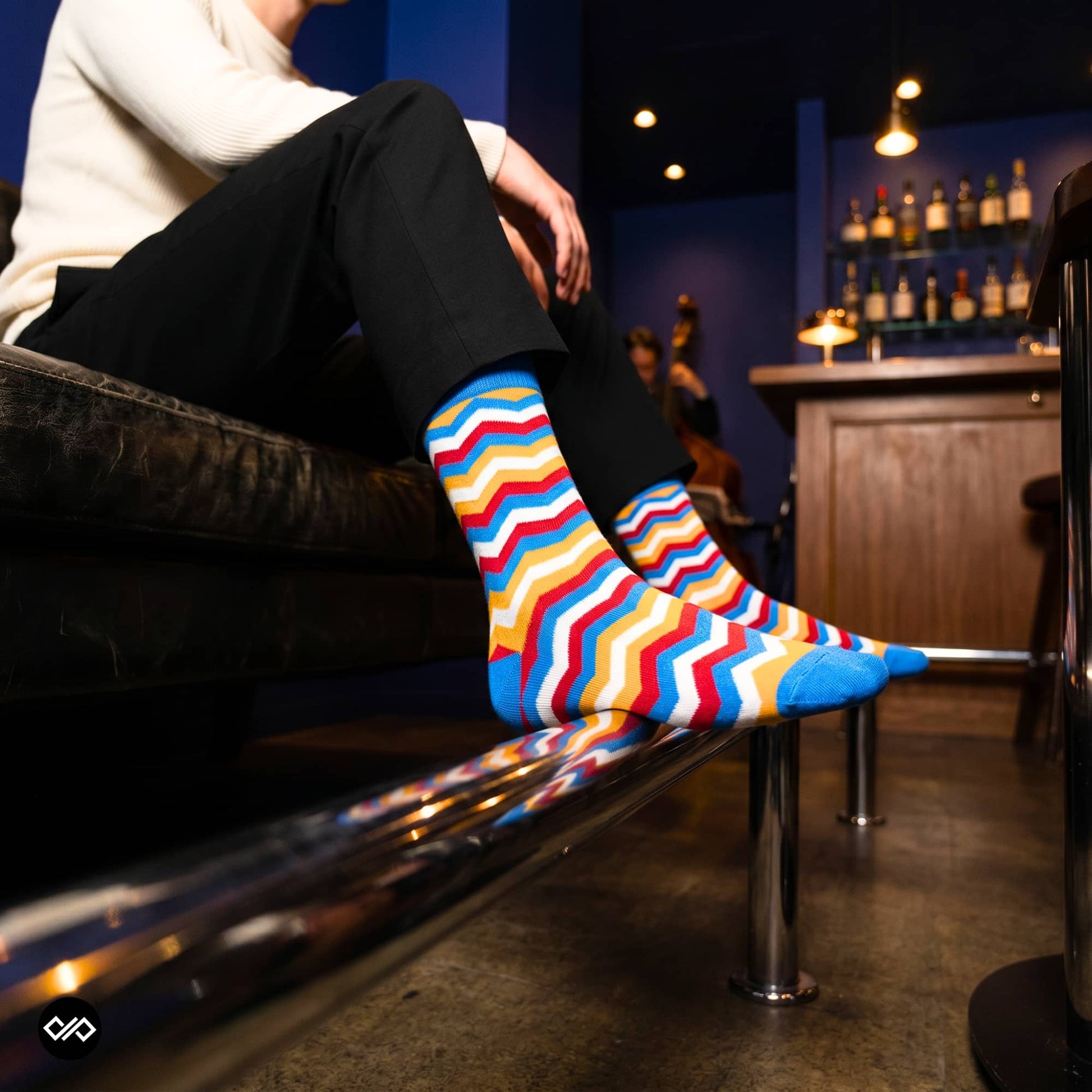 Banger chevron crew socks for men styled with black formal trousers — vibrant designer pattern — Dynamocks