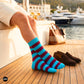 Bold Stripes Aqua Wine crew socks on a Mediterranean yacht at golden hour with brown suede loafers — Dynamocks