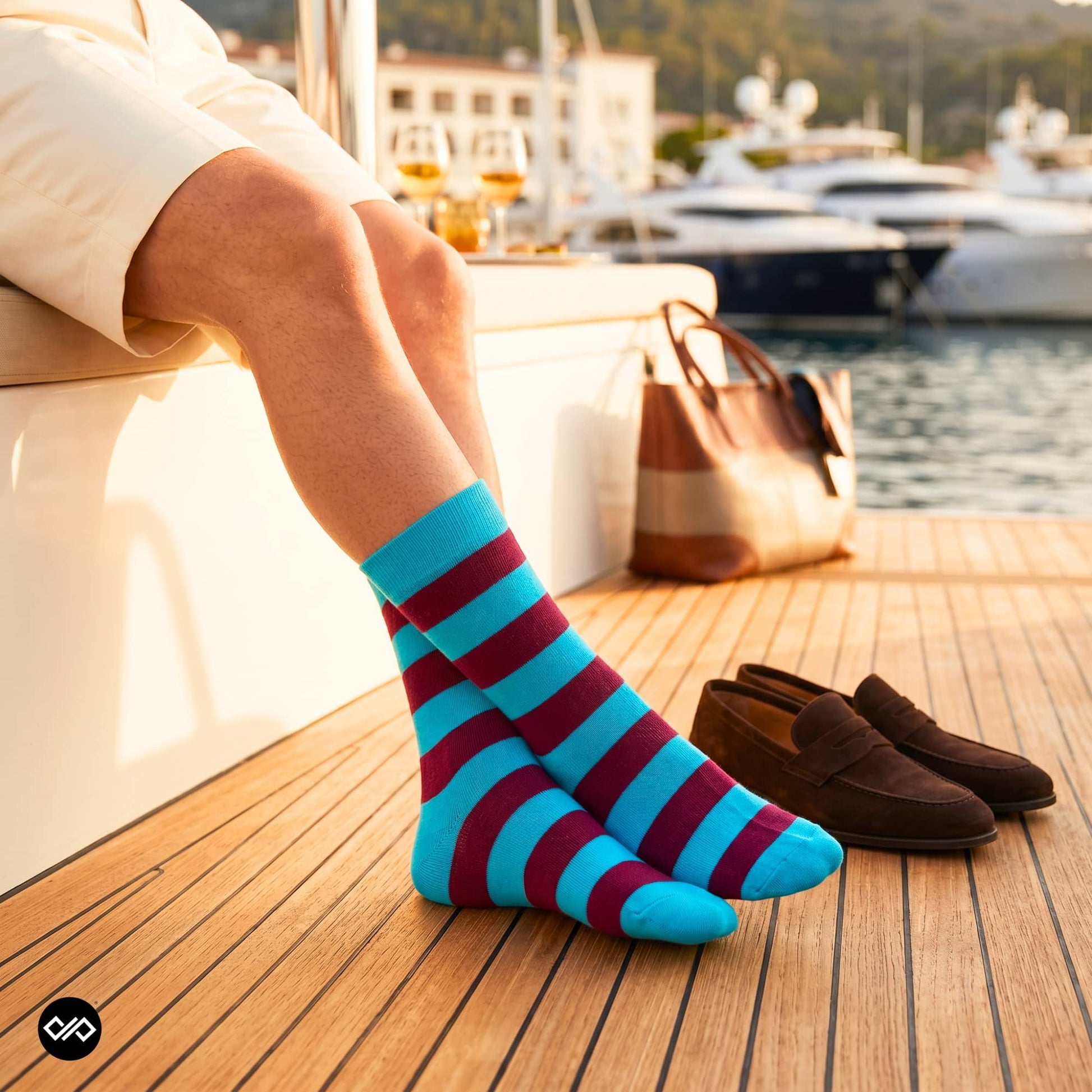 Bold Stripes Aqua Wine crew socks on a Mediterranean yacht at golden hour with brown suede loafers — Dynamocks