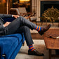 Bold Stripes Blue Orange crew socks paired with charcoal suit trousers and brown monk strap shoes in a luxury lounge — Dynamocks