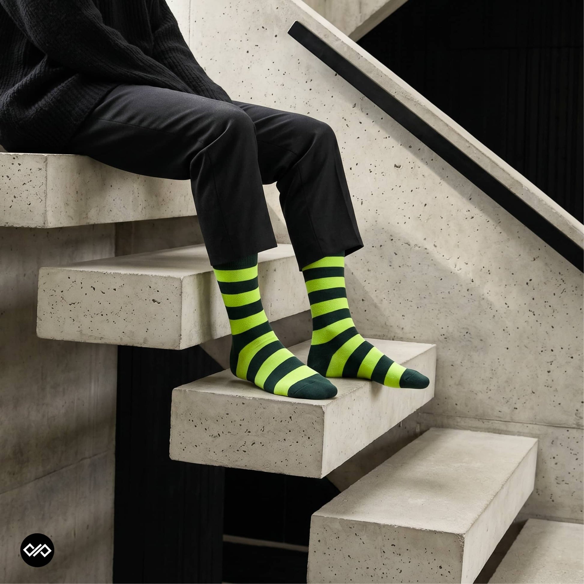 Bold Stripes Neon Green and Olive crew socks worn on modern concrete staircase with black trousers — Dynamocks