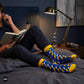 Blue lightning bolt crew socks worn relaxing on a bed at night — Dynamocks India