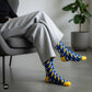 Bolt lightning crew socks styled with grey trousers in a modern living room — Dynamocks