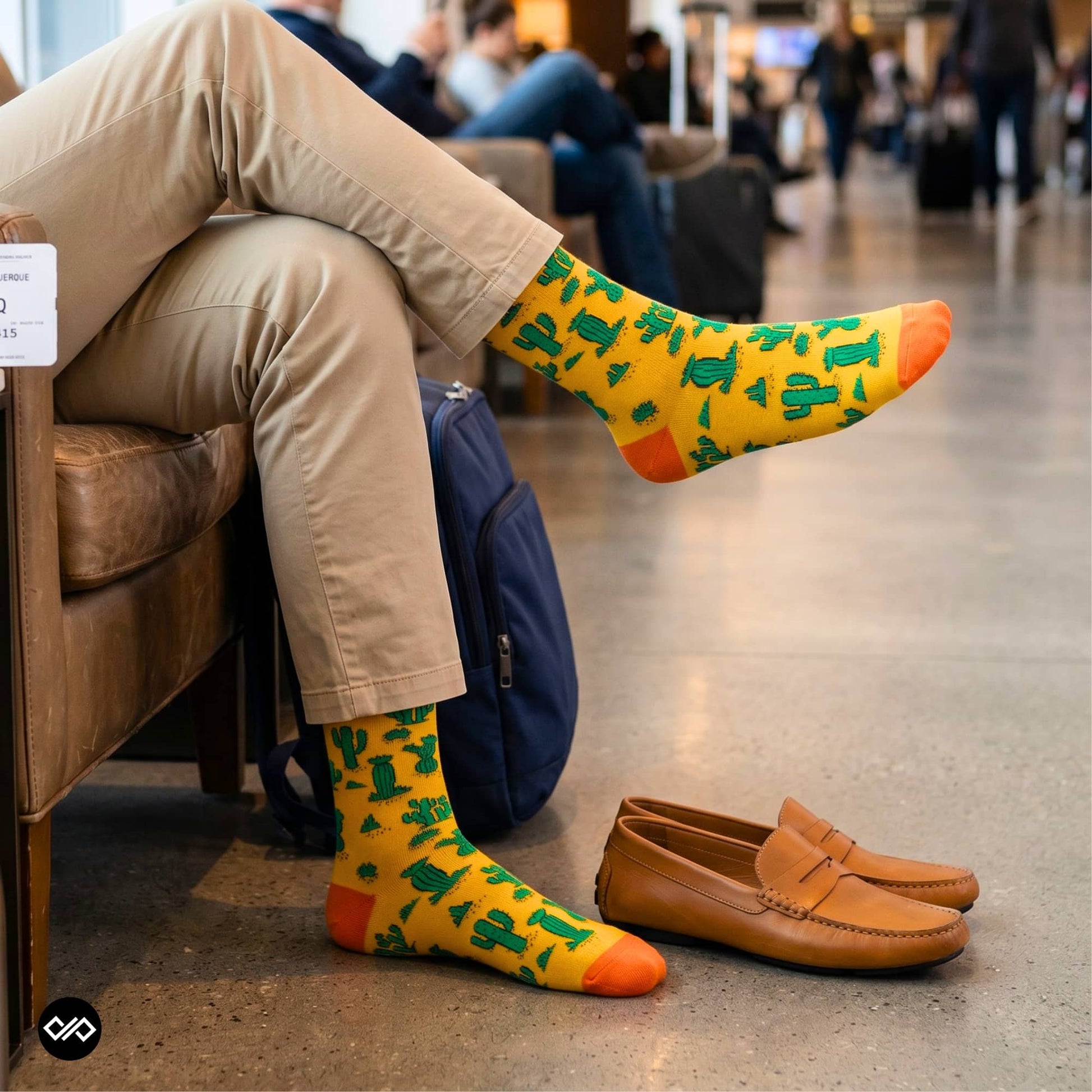 Cactus crew socks paired with khaki chinos and tan loafers in an airport lounge — Dynamocks