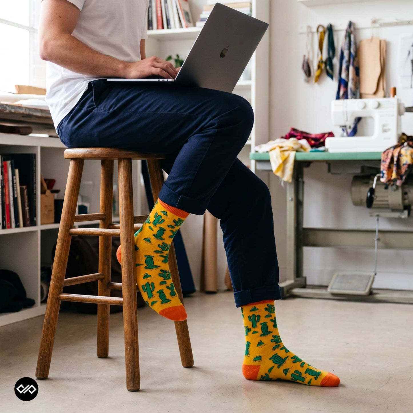Cactus yellow crew socks worn with navy chinos in a creative studio workspace — Dynamocks