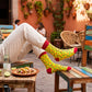 Chillies crew socks styled with rolled cream trousers at a Mexican-style café table with tacos – Dynamocks
