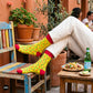 Chillies crew socks styled with rolled cream trousers at a Mexican-style café table with tacos – Dynamocks