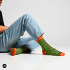 Illusion neon striped crew socks styled with light wash denim on a clean white studio backdrop — Dynamocks India