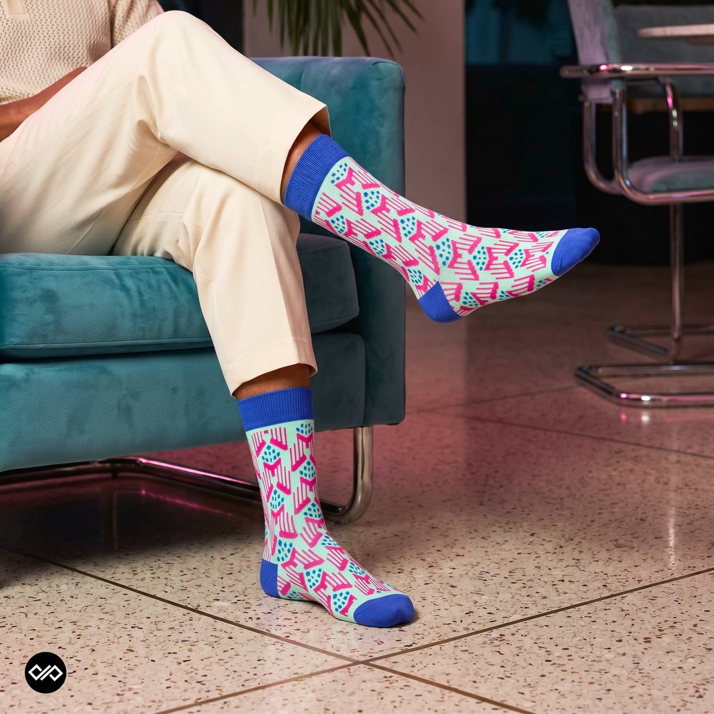 Jazz crew socks styled with cream linen trousers on a teal velvet couch — Dynamocks India