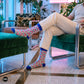 Jazz funky abstract crew socks for men styled with cream trousers in a retro hotel lobby — Dynamocks