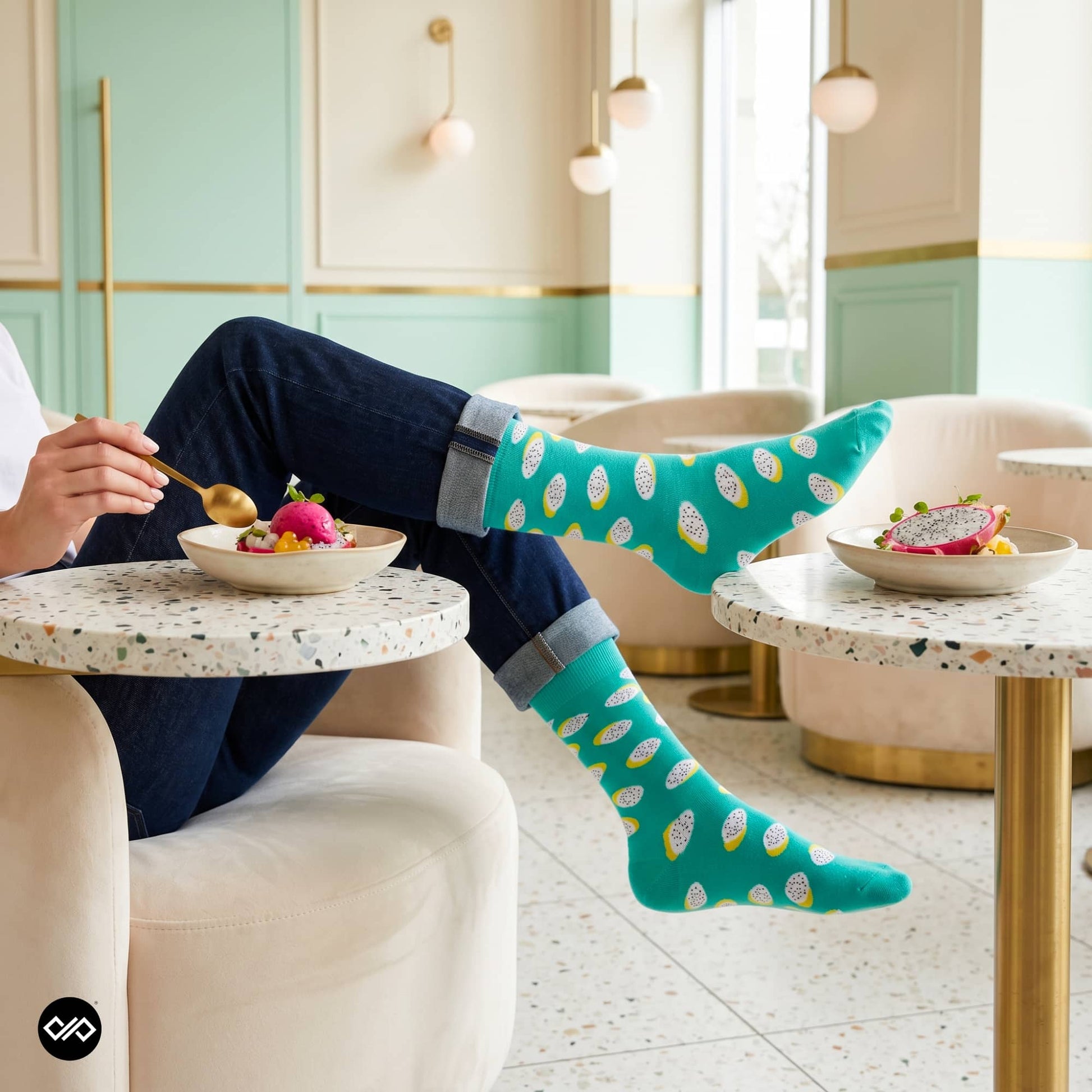 Polka dragon fruit crew socks styled with light wash jeans in a modern café interior — Dynamocks