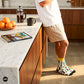 Rickshaw funky crew socks for men styled with beige shorts in kitchen — Indian auto-rickshaw motifs — Dynamocks