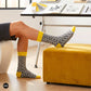 Rogue folk-pattern crew socks styled at a designer's drafting table with Pantone swatches and sketches — Dynamocks