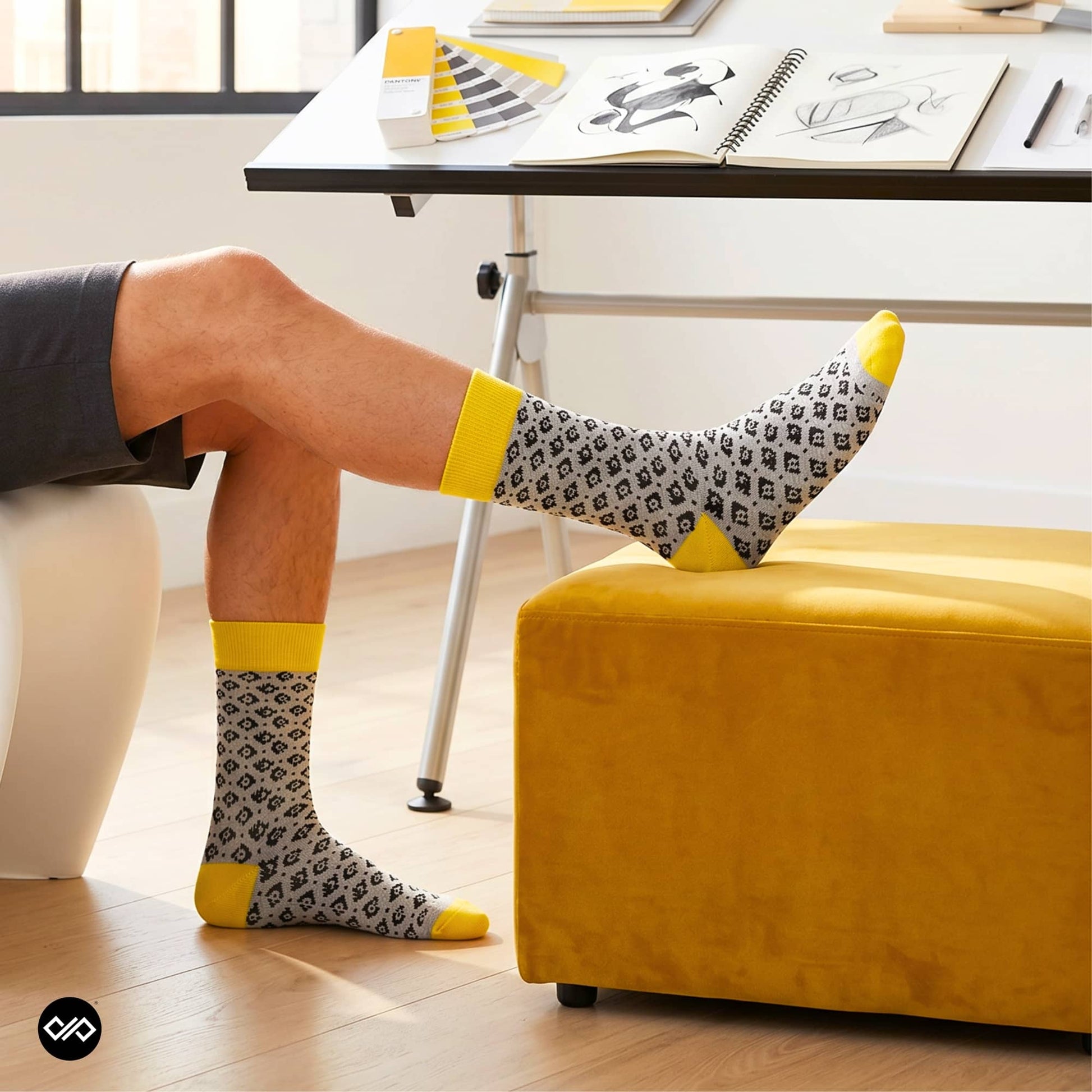 Rogue folk-pattern crew socks styled at a designer's drafting table with Pantone swatches and sketches — Dynamocks
