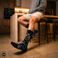 Skeleton crew socks styled with beige shorts and grey hoodie in a modern kitchen — Dynamocks