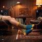 Teal blue and mango striped crew socks for men relaxing in a leather lounge chair with a record player — premium combed cotton designer socks — Dynamocks
