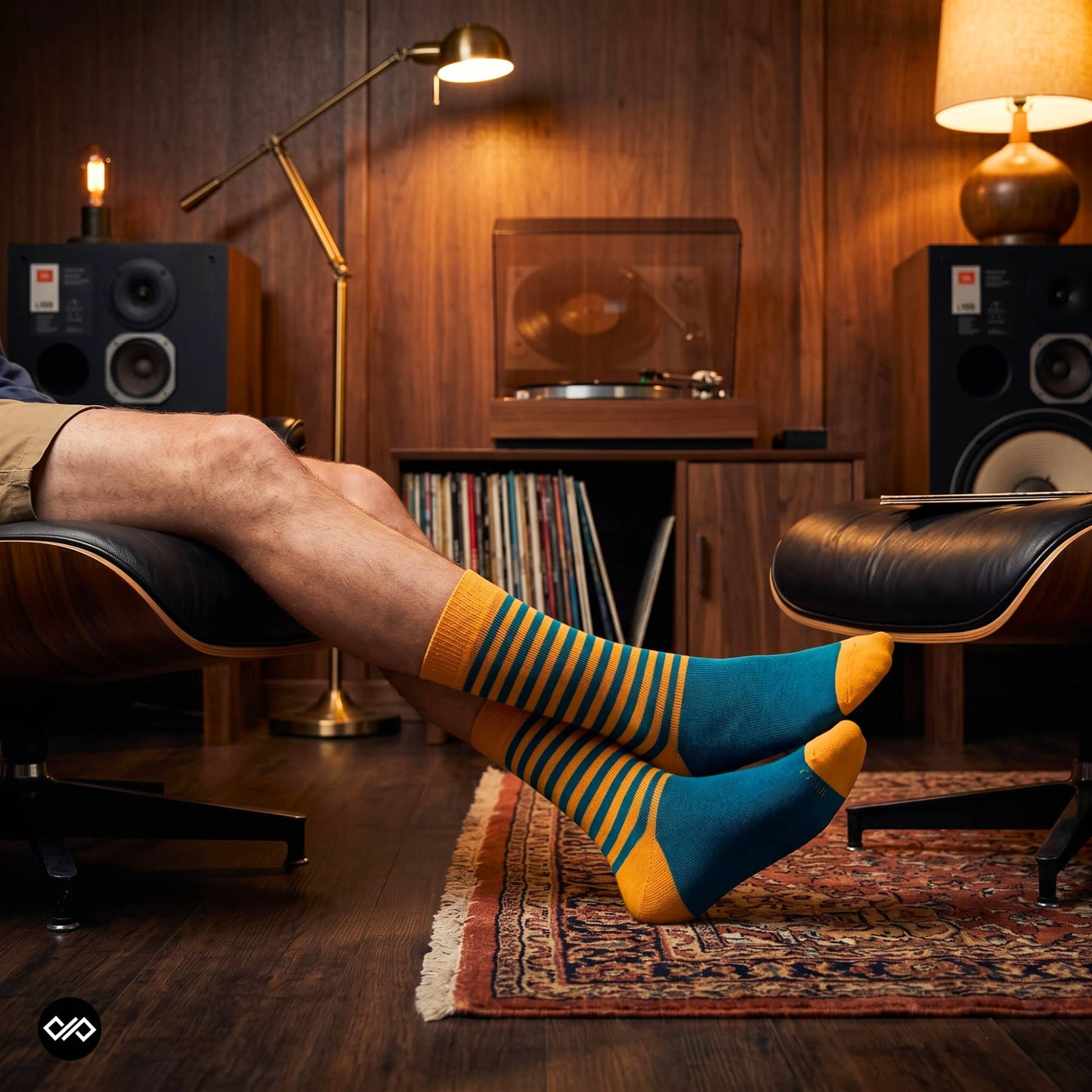Teal blue and mango striped crew socks for men relaxing in a leather lounge chair with a record player — premium combed cotton designer socks — Dynamocks
