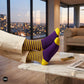 Purple and yellow striped crew socks for men relaxing on a marble table with city view — Dynamocks designer socks