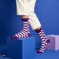 Sublime purple check crew socks for men styled with white trousers on blue studio cubes — Dynamocks India