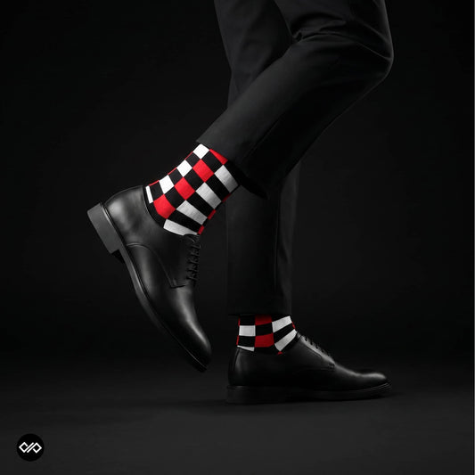 Sublime red check crew socks styled with black trousers and black derby shoes on a dark studio backdrop — Dynamocks