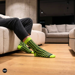 Swank neon green crew socks for men styled in modern apartment — funky designer cotton socks — Dynamocks